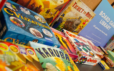 Board game library at Soonercon in the game room