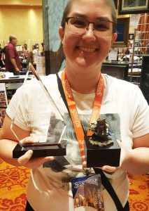 Courtney Merz poses with her Eben Miniature she won the painting contest with. She's also holding the trophy.