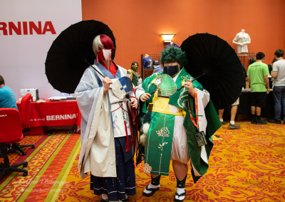 Two guests pose in elaborate My Hero Academia cosplay stylized with Japanese kimonos and umbrellas.