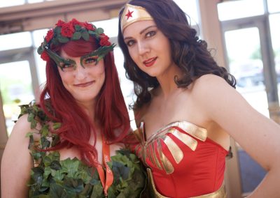 Wonder Woman and Poison Ivy cosplay pose together