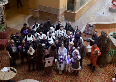 Star Wars Cosplayers look up at the camera being held from above.