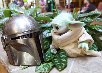 Grogu doll looks at Din Djarin's helmet