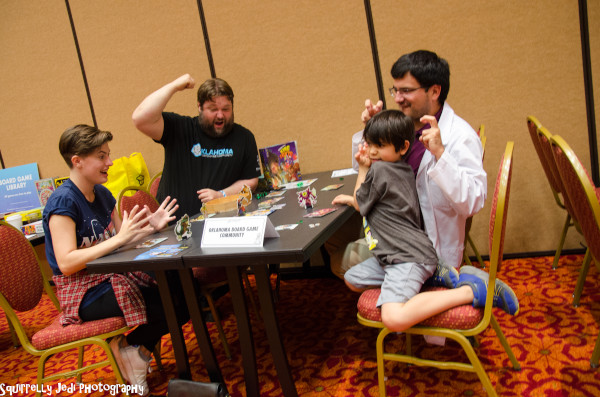 Kids playing the board game King of Tokyo